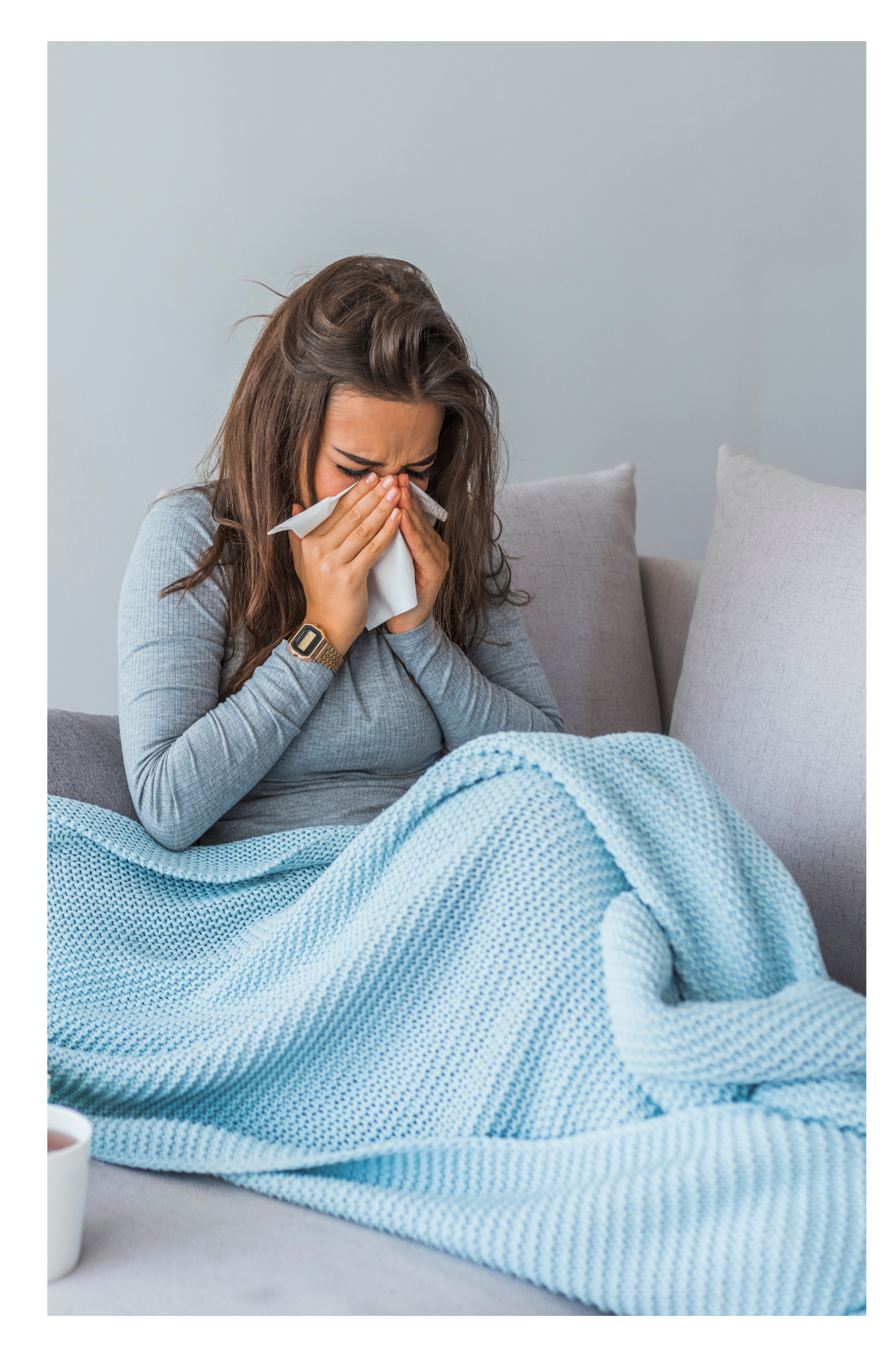Sick woman, sneezing into tissue.