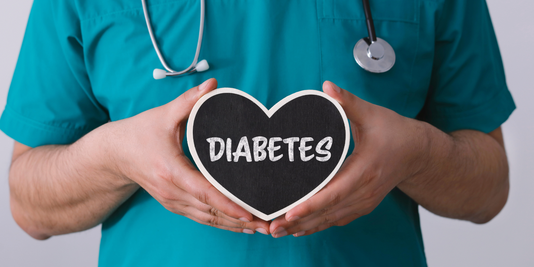 An image of somemone in medical scrubs holding a heart that says diabetes.